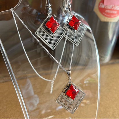 Necklace and earring set with red Swarovski crystals with silver design