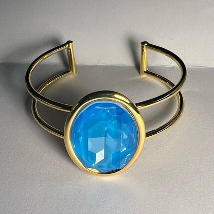 A Gold Handcrafted bracelet with large oval blue Swarovski crystal