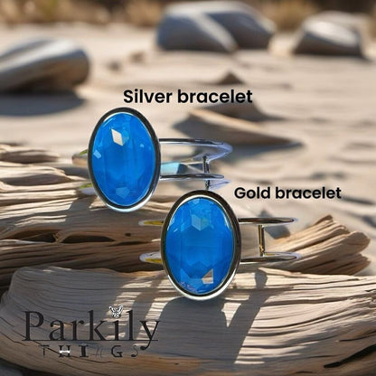 A Gold Handcrafted bracelet with large oval blue Swarovski crystal