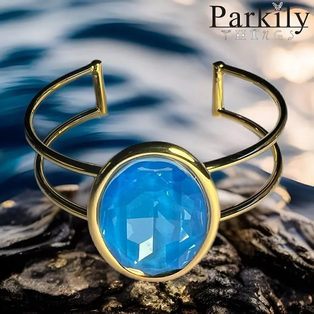A Gold Handcrafted bracelet with large oval blue Swarovski crystal