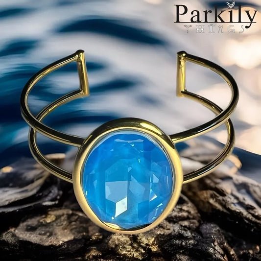 A Gold Handcrafted bracelet with large oval blue Swarovski crystal