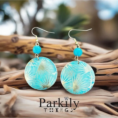 Patina metal earrings with a turquoise shade and gold on earwire